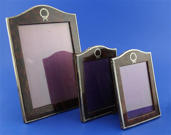 A graduated set of three late 1920s silver and simulated tortoiseshell photograph frames,